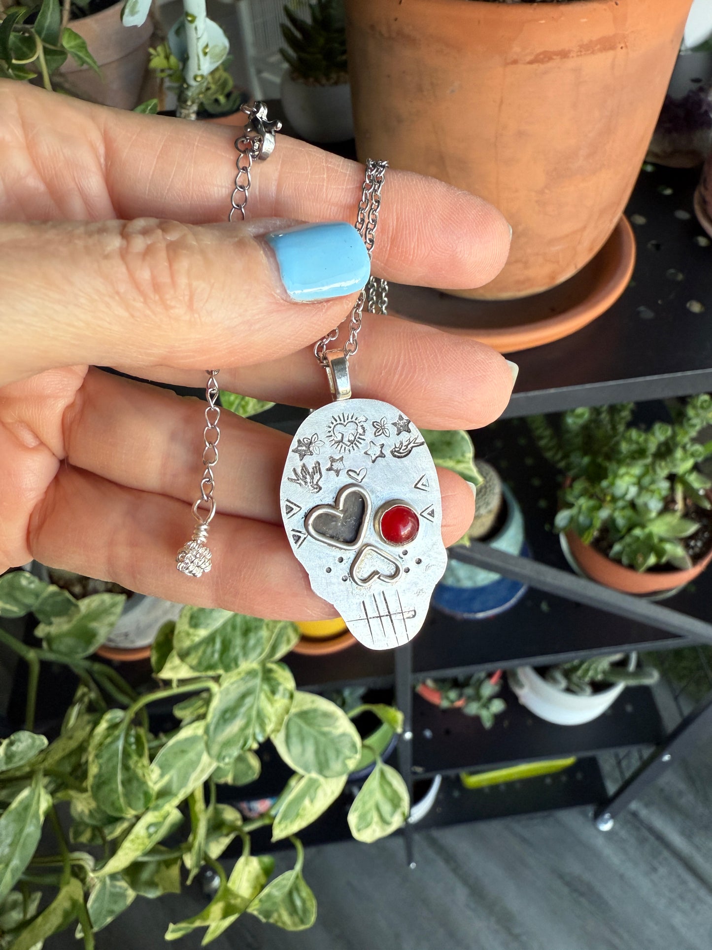 Edgy Coral-Eyed Skull Necklace: Sterling Silver