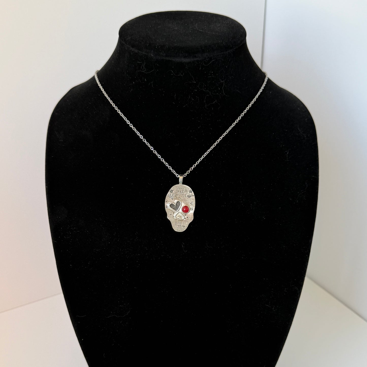 Edgy Coral-Eyed Skull Necklace: Sterling Silver