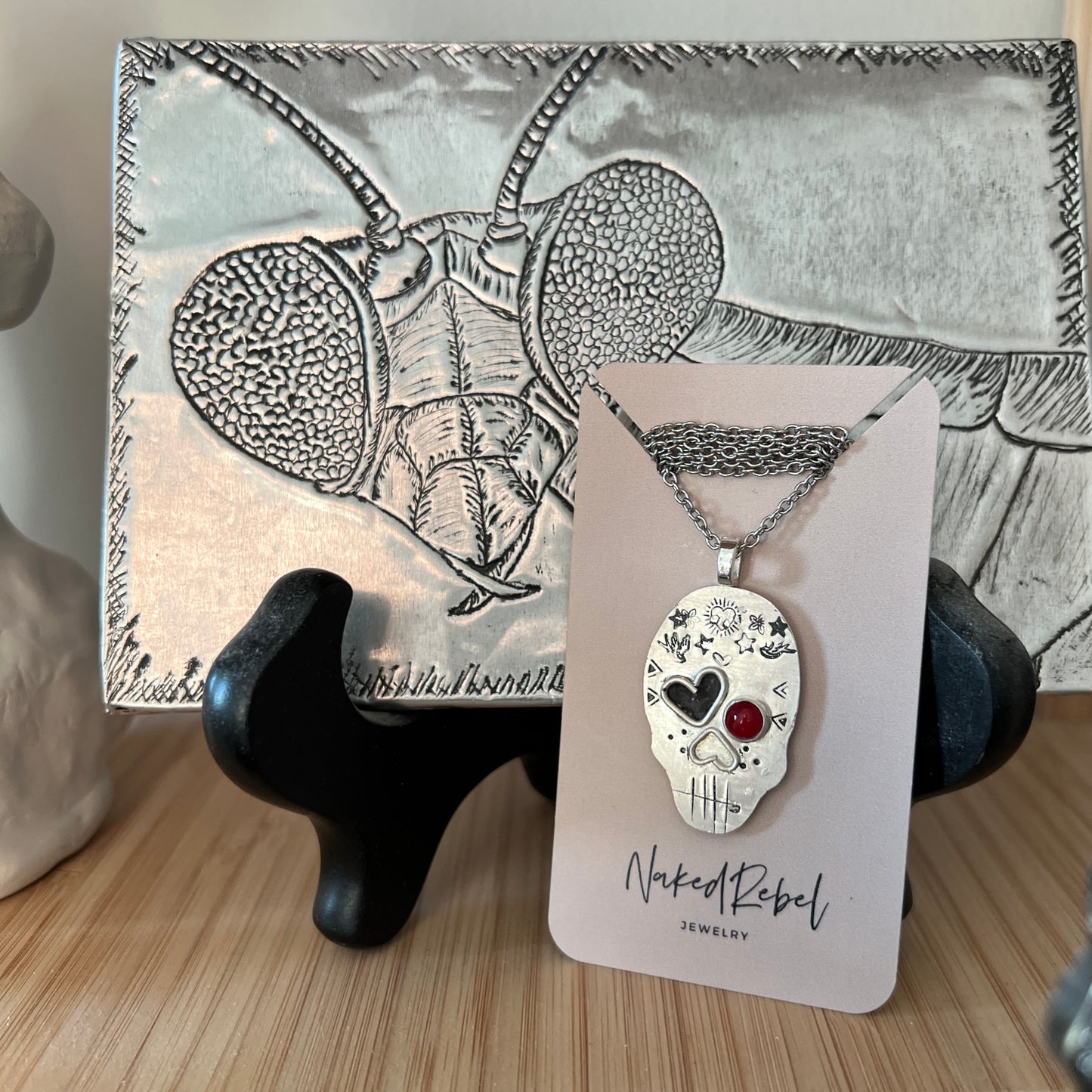 Edgy Coral-Eyed Skull Necklace: Sterling Silver