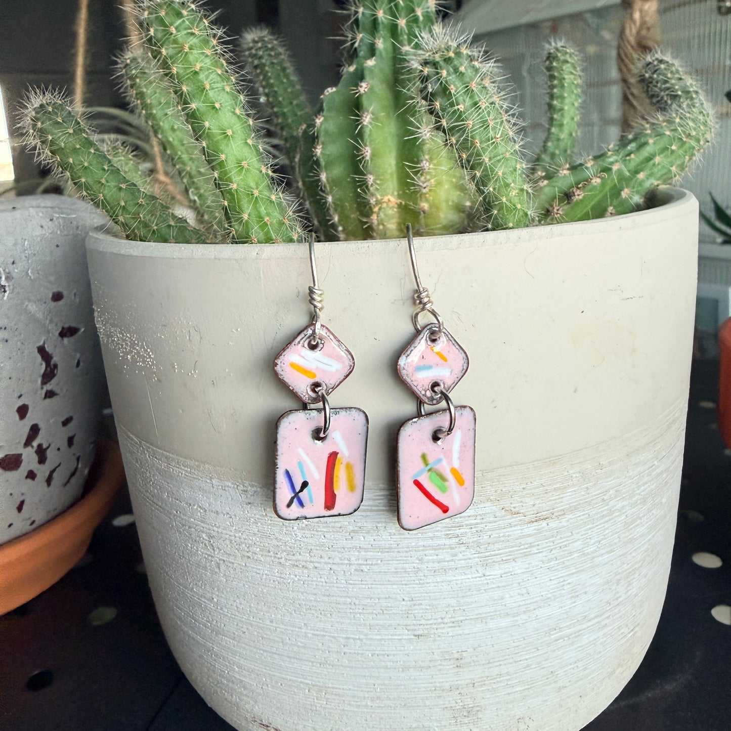 Fun pink enamel earrings, with splashes of color. Sterling Silver ear wires. Handmade.